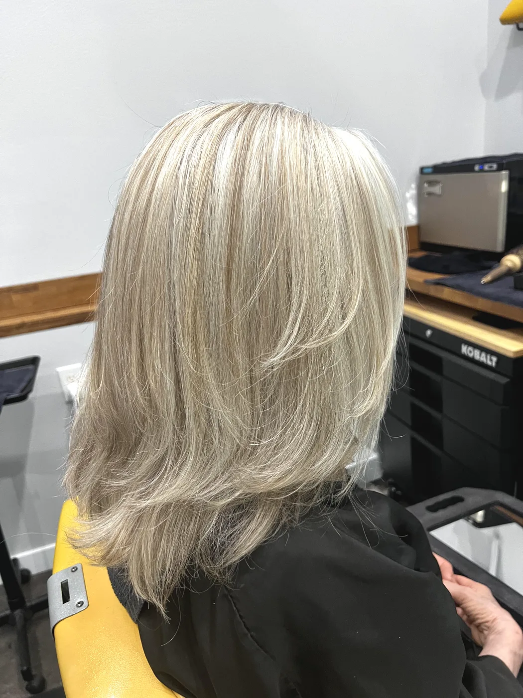 Dimensional blonde full foil highlights with layered blowout at The Gilded Edge, West Seattle salon