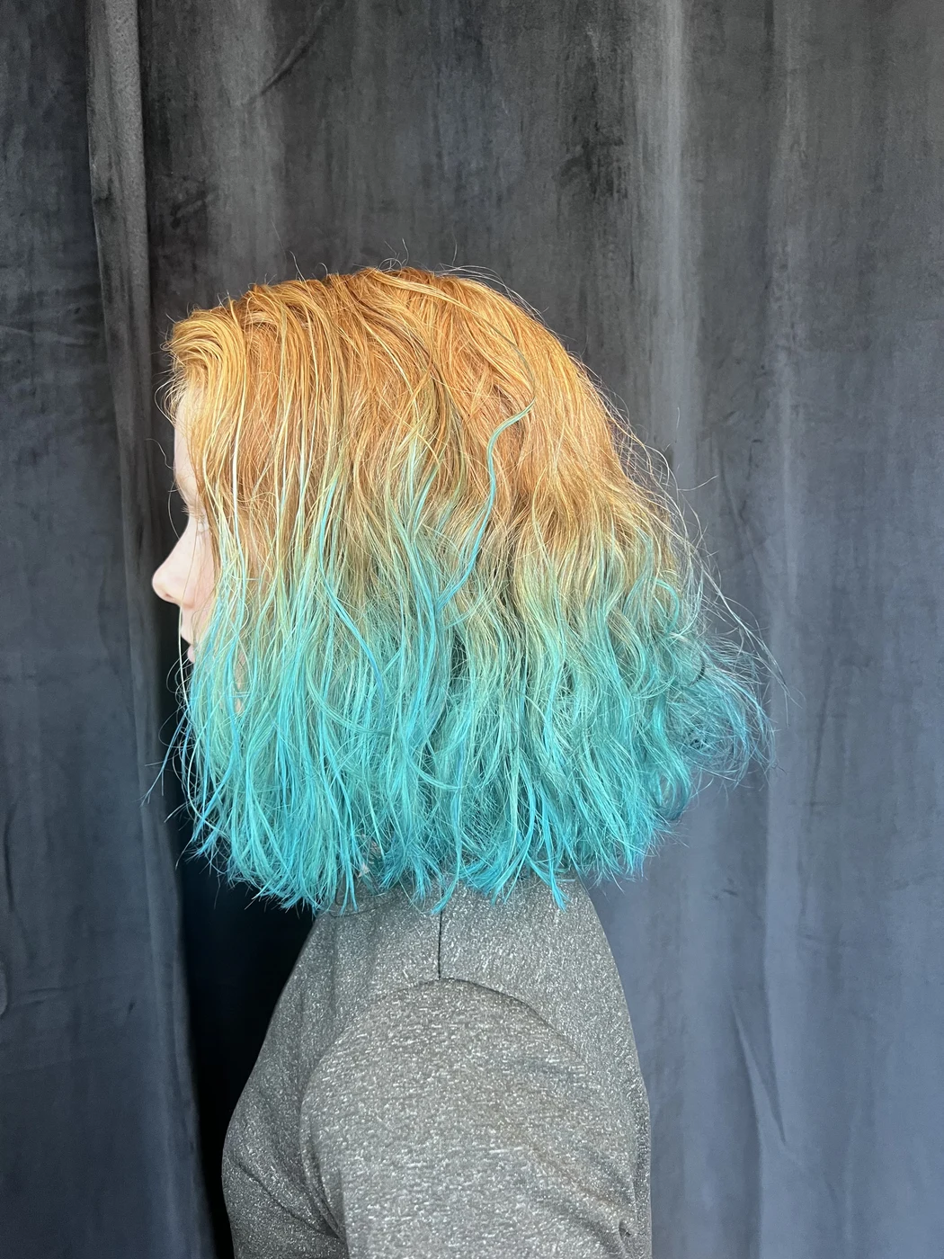 Teal dip dye ombre fashion color on wavy hair at The Gilded Edge, West Seattle salon