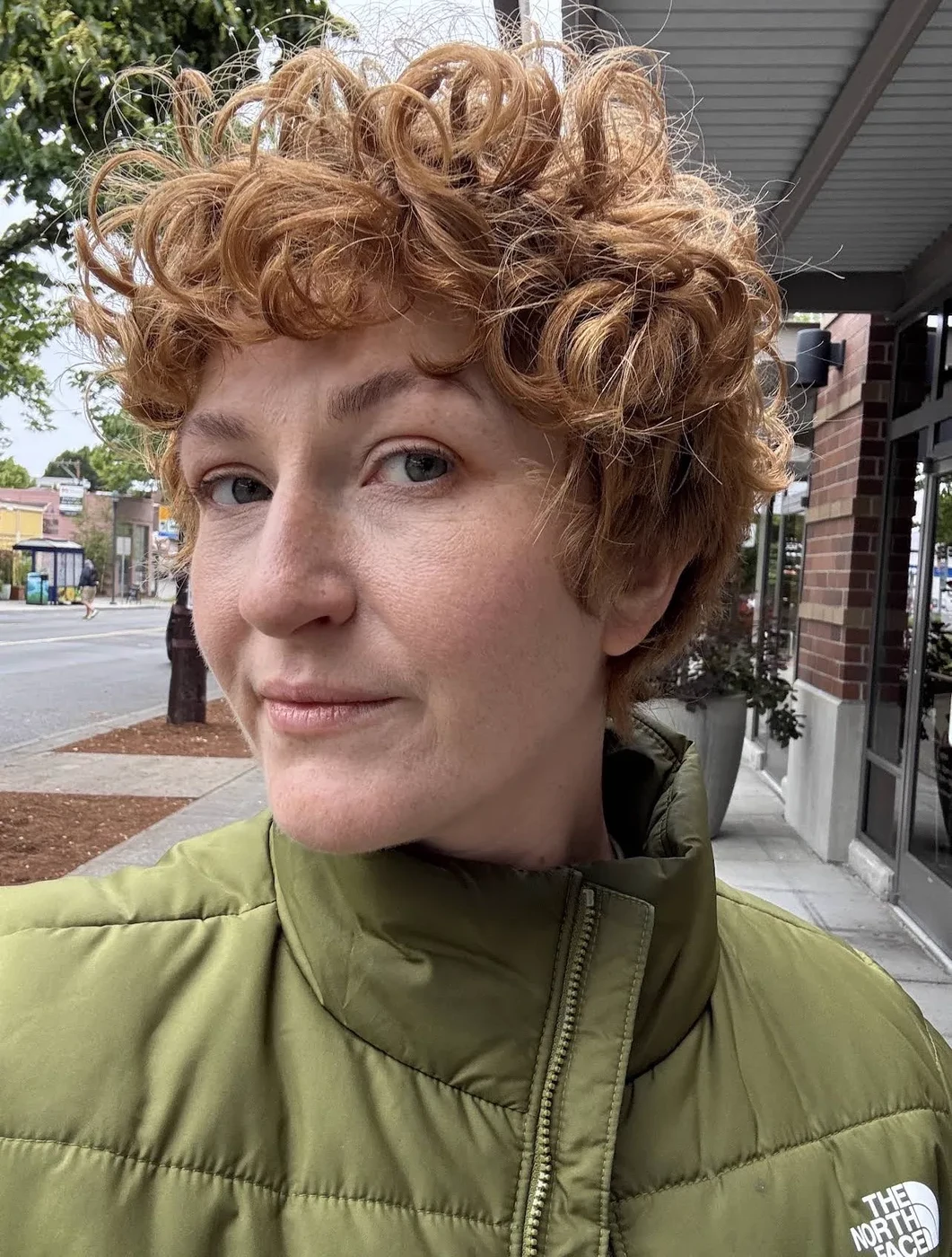 Vivid lime green color on curly fade — fashion haircut West Seattle
